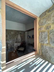 a room with a stone wall and a window at Stazzu Pittorra per 4 persone in Barrabisa +59 photos