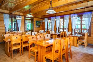 a dining room with wooden tables and chairs at Salaš Vígľaš in Bojnice +94 photos