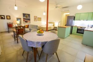 a kitchen and living room with a table with fruit on it at Thalassa Seaside Apartments in Sikéa