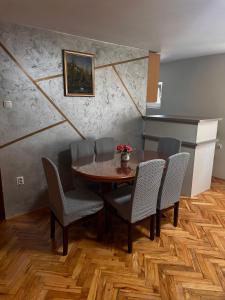 a dining room with a table and chairs at Green Garden Apartments in Surčin