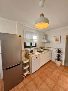 a kitchen with a refrigerator and a sink at Casa en el centro de Nerja- Calle Nueva 21 in Nerja