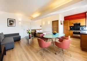 a living room with a couch and a table and chairs at Centerstay Brussels in Brussels
