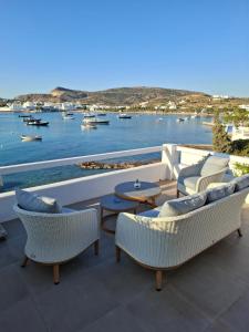 a patio with chairs and tables and a view of the water at Residence 8 BEAUFORT in Pollonia