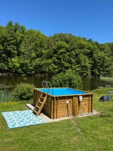 a ping pong table with a slide in the grass at Canopée in Saint-Nabord +8 photos