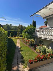 a garden with a bridge and some flowers at Green Garden Apartments in Surčin