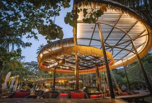 a restaurant with a circular building with tables and chairs at K.B. Resort in Ko Chang
