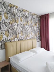 a bedroom with a bed with a floral wallpaper at New Garden in Nago-Torbole +75 photos