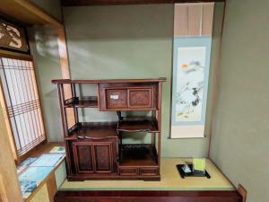 a room with a wooden shelf in a room at Joynest TAKAMATSU in Takamatsu