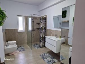 a bathroom with a shower and a sink and a toilet at Apartament 3D in Fălticeni
