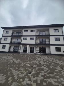 a large white building with a lot of windows at Apartament 3D in Fălticeni