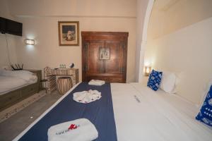 a bedroom with a bed with two towels on it at Riad Blue Berry & SPA in Marrakesh