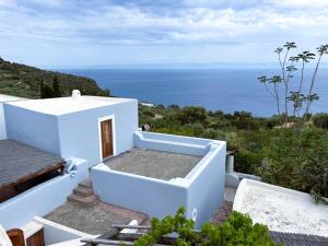 a white house with a view of the ocean at Casa del Limone in Filicudi