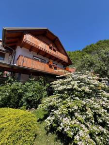 a house on a hill with flowers in front of it at Rooms Ravnik in Bled +60 photos