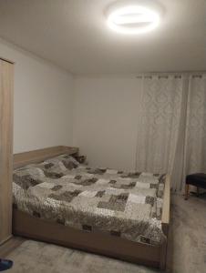 a bedroom with a bed with a comforter on it at Cozy Apartment Koblenz in Koblenz