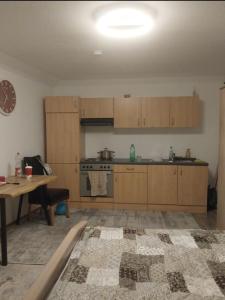 a kitchen with wooden cabinets and a table and a tableablish at Cozy Apartment Koblenz in Koblenz