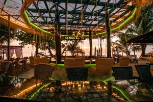 a restaurant with chairs and a table with a view of the ocean at K.B. Resort in Ko Chang