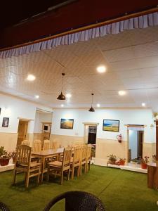 a dining room with a table and chairs at Odbar Guest House Best Guest House at Leh Ladakh in Leh