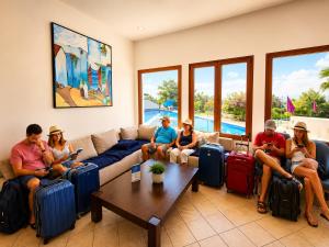a group of people sitting on a couch with luggage at Appart Hôtel Cabo Dream in Cabo Negro