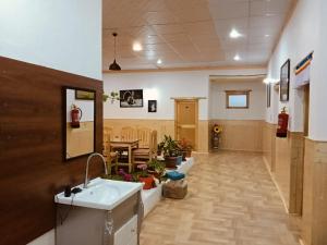 a hospital hallway with a sink and a table at Odbar Guest House Best Guest House at Leh Ladakh in Leh