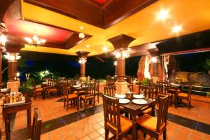 a restaurant with tables and chairs in a patio at Sea Breeze Resort - SHA Plus in Haad Rin