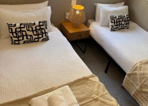 two beds sitting next to each other in a room at Casa en el centro de Nerja- Calle Nueva 21 in Nerja +9 photos
