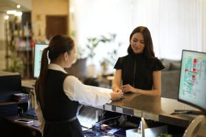two women standing at a cash register in a store at Golden Dragon in Bishkek +92 photos