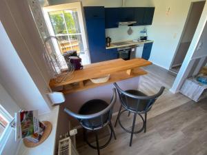 a kitchen with two chairs and a wooden table at Ferienwohnung-Wildblume in Petersdorf auf Fehmarn