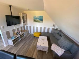 a living room with a couch and a table at Ferienwohnung-Wildblume in Petersdorf auf Fehmarn