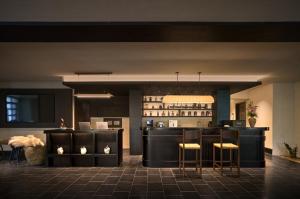 a restaurant with a bar with stools in a room at Chengdu Yunduo Bieyuan 云朵 Hotel in Chengdu