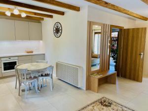 a kitchen and dining room with a table and chairs at Noclegi Na Górze - Obrocz 116 in Obrocz