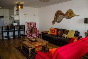 a living room with a couch and a table at Greenways Emerald Bay in Strand
