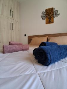 a bed with two towels on top of it at Elegance Apartments Mesologgi in Missolonghi