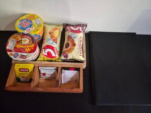 a shelf with chips and other food items on it at Aira Private Pool Glamping in Bandung