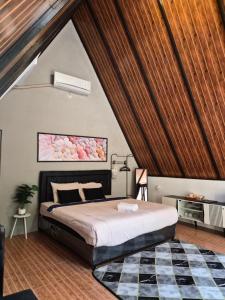 a bedroom with a large bed in a attic at Aira Private Pool Glamping in Bandung