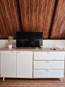 a white cabinet with a tv on top of it at Aira Private Pool Glamping in Bandung