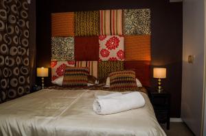 a bedroom with a large bed with two pillows at Greenways Emerald Bay in Strand