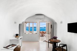 a living room with a view of the ocean at Nano Oia Villas in Oia