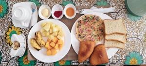 a table with two plates of bread and other foods at primavera jambiani in Mfumbwi