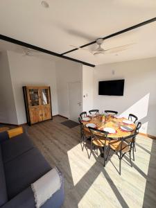 a living room with a table and a couch at Grand Appartement - Pétrel 2 in Trois Bassins