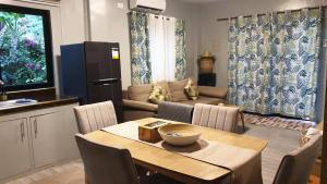 a kitchen and living room with a table and a dining room at Tambisan Resort in Siquijor