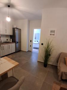 a kitchen and a living room with a table at Elegance Apartments Mesologgi in Missolonghi +26 photos