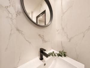 a bathroom sink with a mirror and a faucet at Centerstay Brussels in Brussels +92 photos