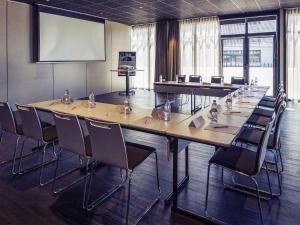 a conference room with a long table and chairs at Mercure Cherbourg Centre Port in Cherbourg en Cotentin