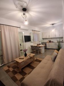 a living room with a couch and a table at Elegance Apartments Mesologgi in Missolonghi