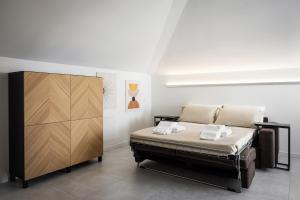 a bedroom with a bed and a wooden cabinet at Antares b&b in Cassina deʼ Pecchi