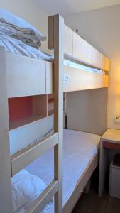 a room with two bunk beds and a desk at Studio cabine climatisé vue golf à Cap Estérel in Saint-Raphaël +13 photos