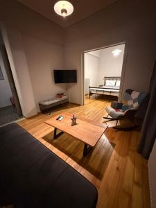 a living room with a couch and a coffee table at Skyfall with a large balcony and FREE parking in Central Kiato in Kiaton