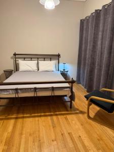 a bedroom with a bed and a chair in it at Skyfall with a large balcony and FREE parking in Central Kiato in Kiaton +9 photos