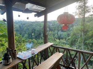 a balcony of a house with a view of the forest at Homestay Vườn Cam in Kon Von Kla +19 photos