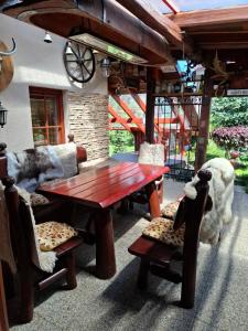 a patio with a wooden table and chairs at Chalupa u Záhradníkov in Trebostovo